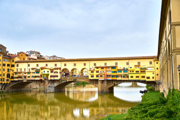 Famous bridge "Ponte Vecchio" at cloudy day in Florence in Italy