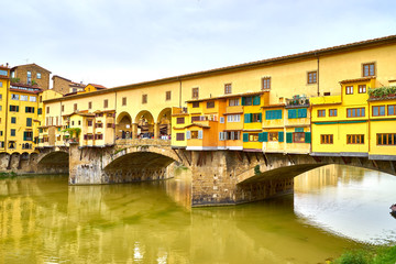 Famous bridge "Ponte Vecchio" at cloudy day in Florence in Italy
