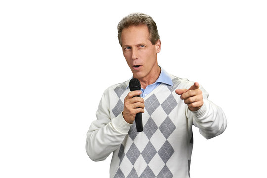 Man with microphone indicating with finger. Office man presenter with microphone gesturing isolated on white background.