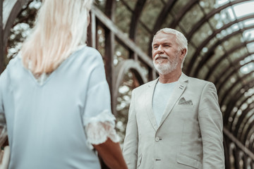 Fall in love. Pleased male expressing positivity while having romantic date