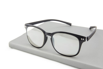 Reading glasses with books isolated on the white background