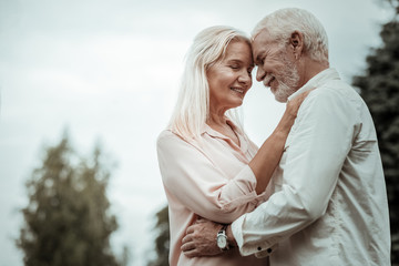 Obraz premium Enjoying silence. Pretty blonde keeping eyes closed while expressing her love