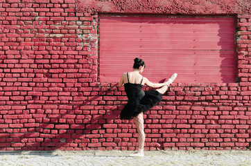 Ballerina stretching legs outside