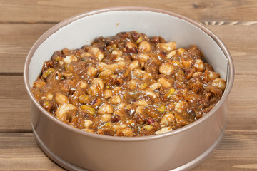 Panforte Preparation, Cooking Process. Raw Mix Of Nuts, Figs, Spices In Baking Tray. Rice Paper.