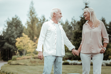 Like in childhood. Happy woman keeping smile on her face while looking at her partner