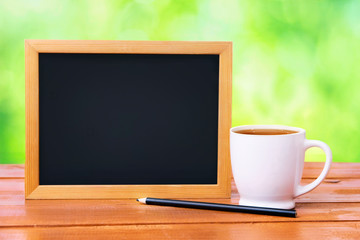 
A board for notes and a white mug with tea on a wooden table