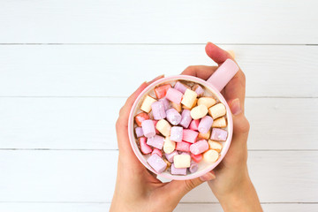 Christmas cocoa with marshmallow in a pink cup