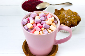 Christmas cocoa marshmallow pink cup and ginger biscuit white wooden table raspberry jam