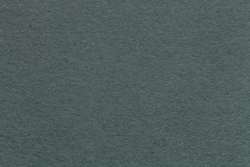 Texture of old green paper background, closeup. Structure of dense gray cardboard