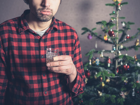 Sad and depressed man with drink at christmas
