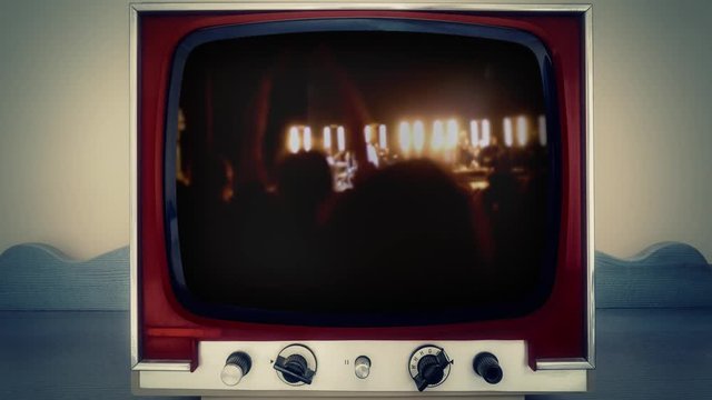 A Retro Vintage TV Showing The Cheering Crowd At The End Of A Pop-rock Concert, From Behind.
