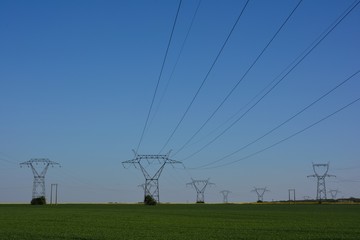 Electricity pylons in farmland, France. 