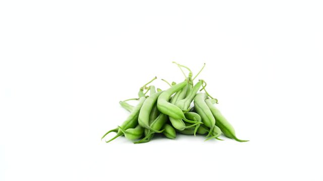Heap of fresh green bean pod. Rotating on the turntable isolated on the white background. Close up. Macro.
