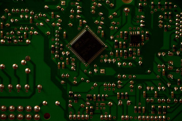 Microelectronics hardware concept. Industry, computing. The back side of the PCB with chip.