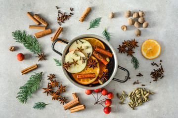 Christmas mulled wine with apple, orange and spices, hot drink cooking