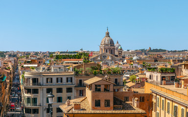 Fototapeta na wymiar View of the roofs of houses and Via Condotti in Rome city from Trinita dei Monti church, Rome, Italy