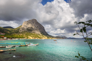 Fototapeta na wymiar Dramatic thunder sky, clouds but sunny cape in Black Sea, Novyi Svet, Crimea