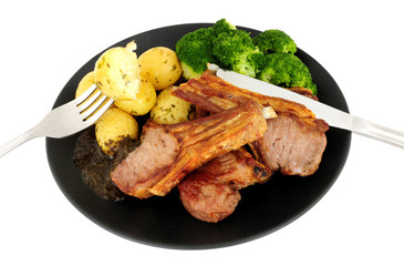 Grilled lamb cutlet meal with new potatoes and broccoli isolated on a white background