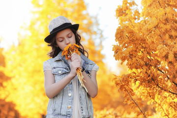 Girl walking in the autumn park. Autumn in the city, girl with d