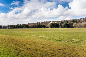 Football Pitches in a Park with a Wooded Hill in Background on a Sunny Winter Day. Dundee, Scotland, UK.