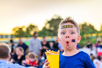 Cute Australian boy with flag tattoo on his face