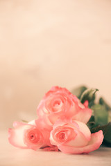 Bunch of pink roses on concrete background. Surprise Valentine's Day, soft color toned. Copy space
