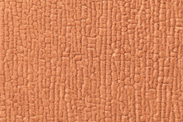 Orange luffy background of soft, fleecy cloth. Texture of textile closeup