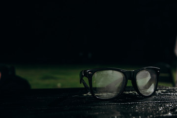 Black glasses on the table at night