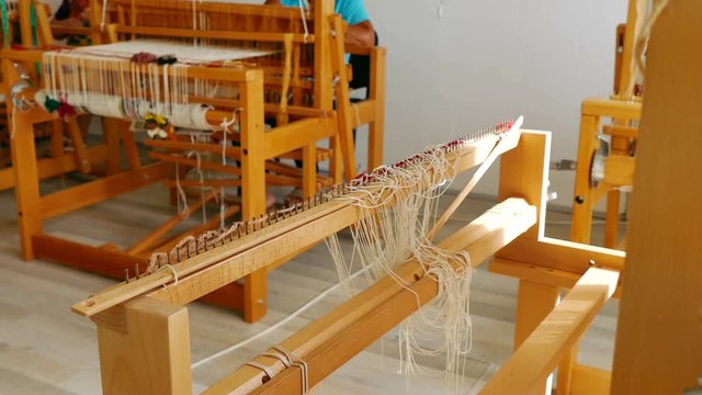 Woman weaving a rug on a wooden loom, 4k Video Clip