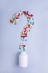 Question mark from Colorful medicines. Pills, tablets capsules. Medical concept How to choose a pharmaceutical product