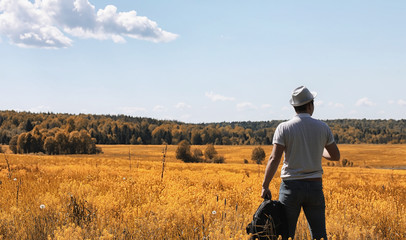 A young man is traveling in nature. Traveling with a backpack on