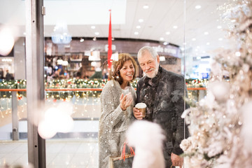 A happy senior couple doing Christmas shopping.