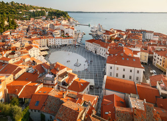 Beautiful sunset aerial view on Piran town with Tartini main square, ancient buildings with red roofs and Adriatic sea in southwestern Slovenia
