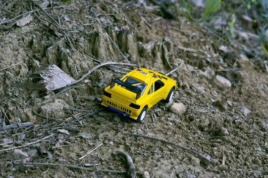 A yellow sport racing car running on a mountain road.