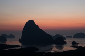 Island with great mountain silhouette with beautiful sunrise sky. From Samet Nangshe viewpoint, Phang Nga, Thailand.