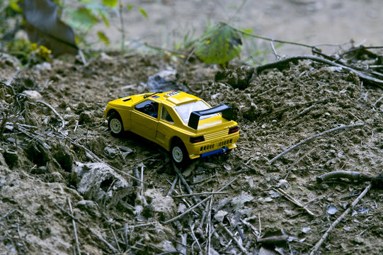 A yellow sport racing car running on a mountain road.