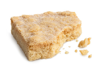 Classic homemade square shortbread biscuit isolated on white. Partially eaten.