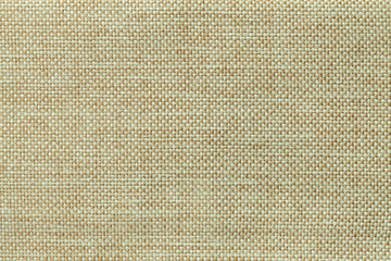 Light green background of dense woven bagging fabric, closeup. Structure of the textile macro.