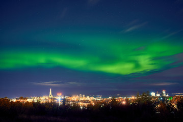 northern lights above Reykjavik in Iceland at night