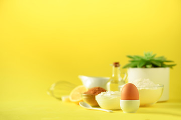 Healthy baking ingredients - butter, sugar, flour, eggs, oil, spoon, brush, whisk, milk over yellow background. Banner. Bakery food frame, cooking concept with succulent plant. Copy space.