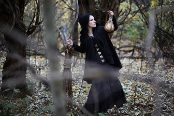 A woman in a witch suit in a forest