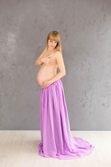 pregnant girl. pregnant with purple. blonde. a girl with a tummy