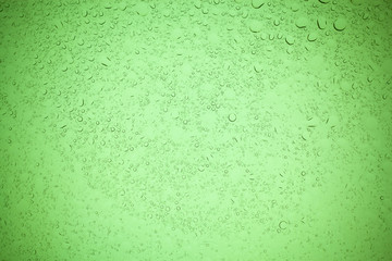 Rain droplets on green glass background, Water drops on green glass.