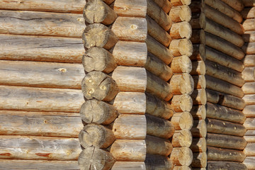 Wall with log house in the house as a background