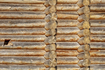 Wall with log house in the house as a background
