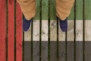 man stepped on a flag of UAE painted on a wooden floor