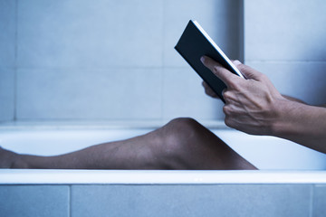 man reading in bathtub in a mysterious atmosphere.