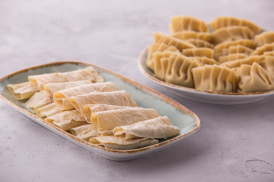 Home made chinese and korean steamed dumplings served on plate with soy sauce