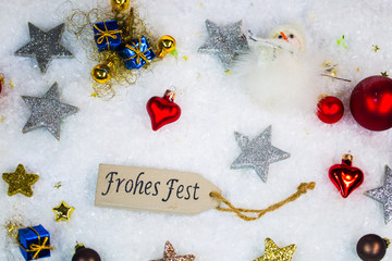 Happy holiday with christmas balls and stars in the snow