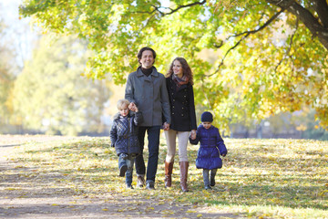 Naklejka na ściany i meble Family with children in autumn park
